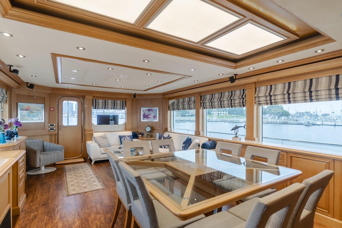 a large room with a table and chairs aboard UNDAUNTED Yacht for Sale