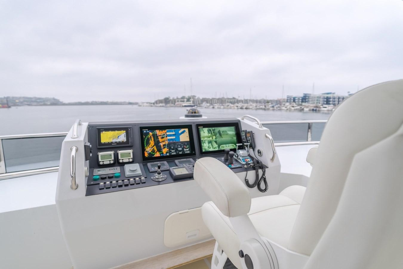 a view of a boat with a computer and a view of the city aboard UNDAUNTED Yacht for Sale