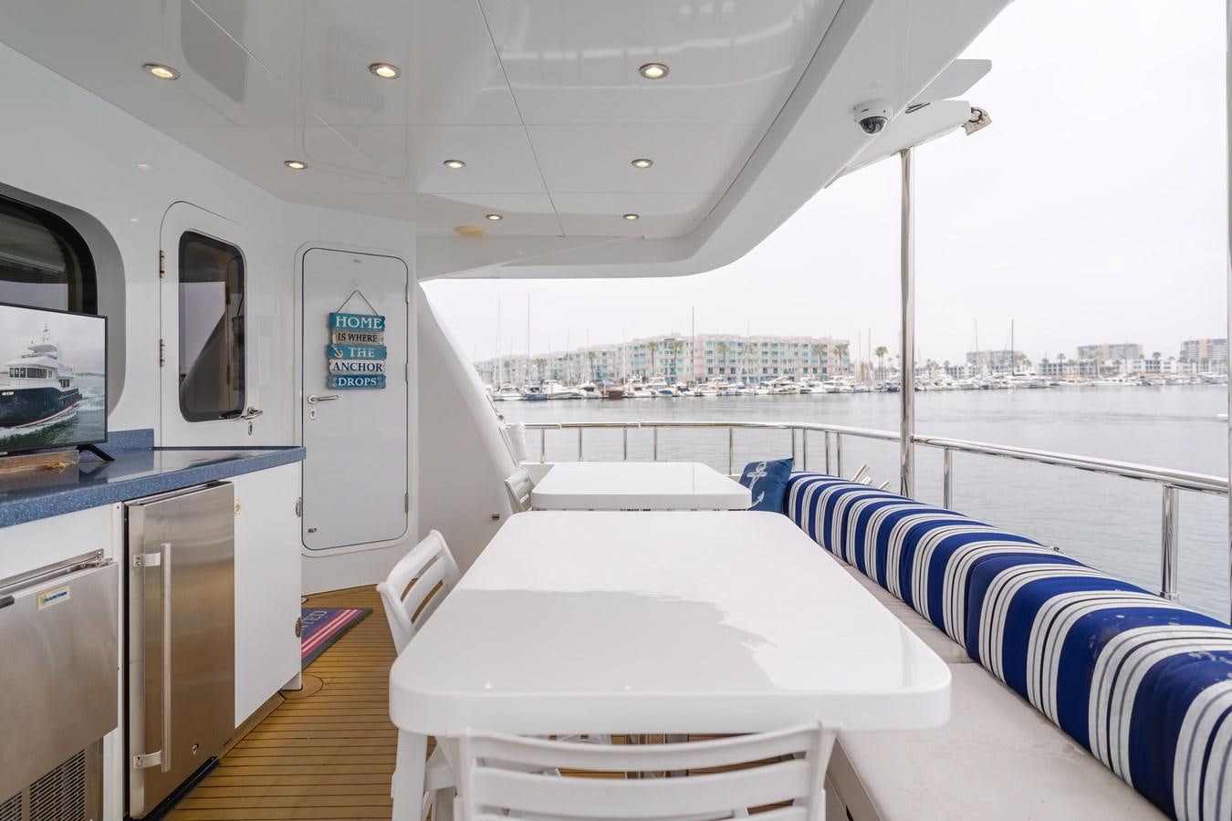 a boat with a table and chairs aboard UNDAUNTED Yacht for Sale