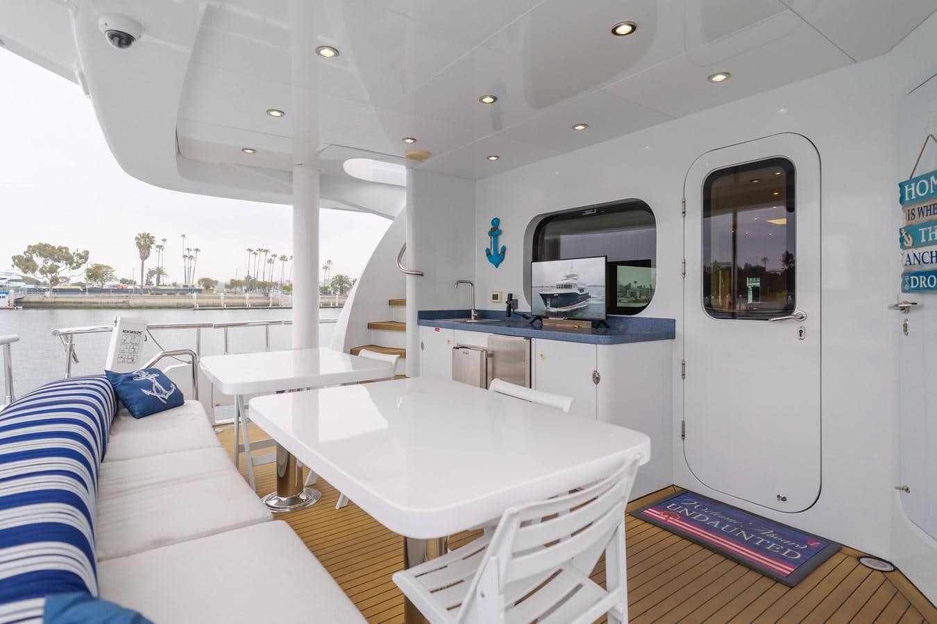 a room with a table and chairs aboard UNDAUNTED Yacht for Sale