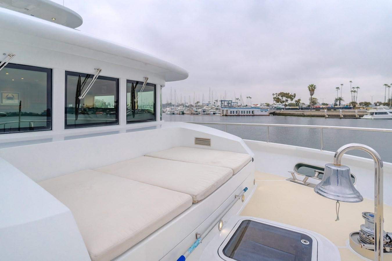 a white bed on a boat aboard UNDAUNTED Yacht for Sale