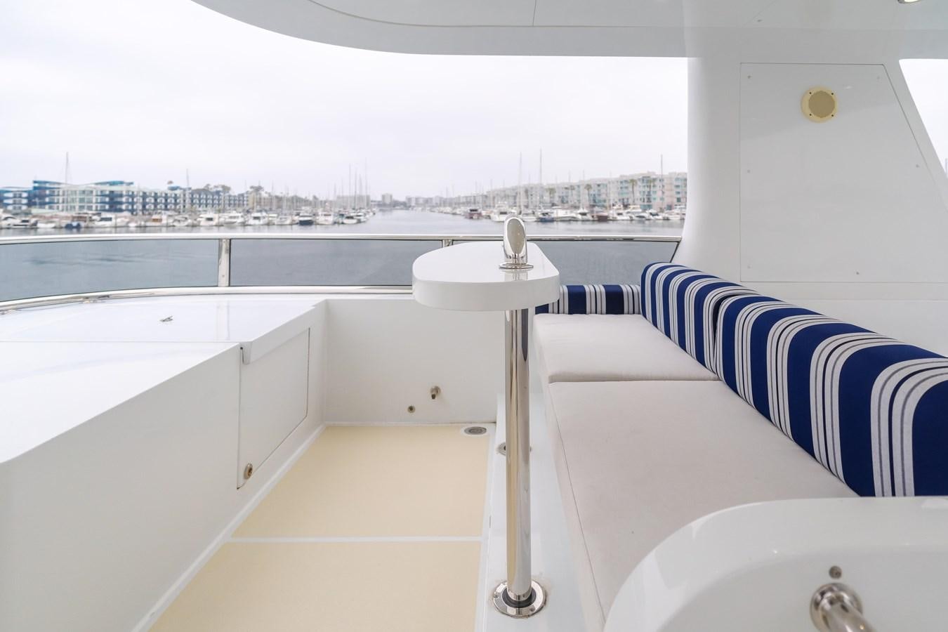 a white table and a white table in a room with a view of a city aboard UNDAUNTED Yacht for Sale