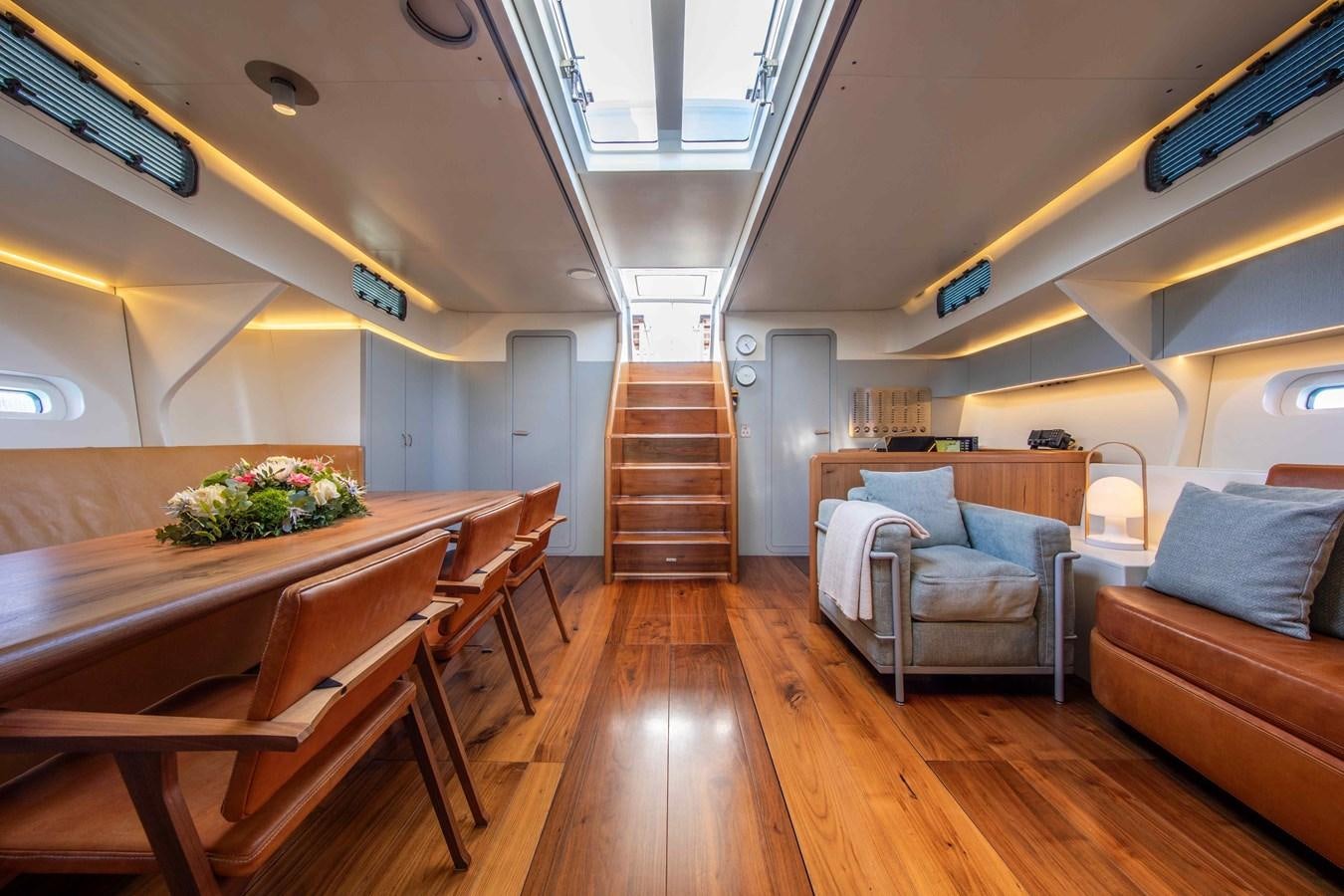 a room with a wood floor and a table and chairs aboard PEREGRIN Yacht for Sale