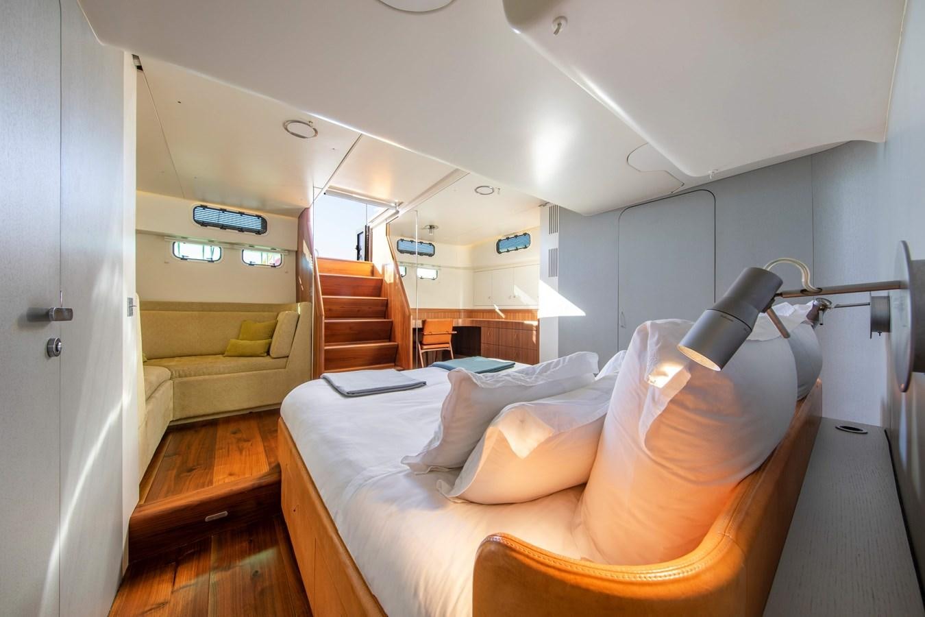 a room with a bed and a chair aboard PEREGRIN Yacht for Sale