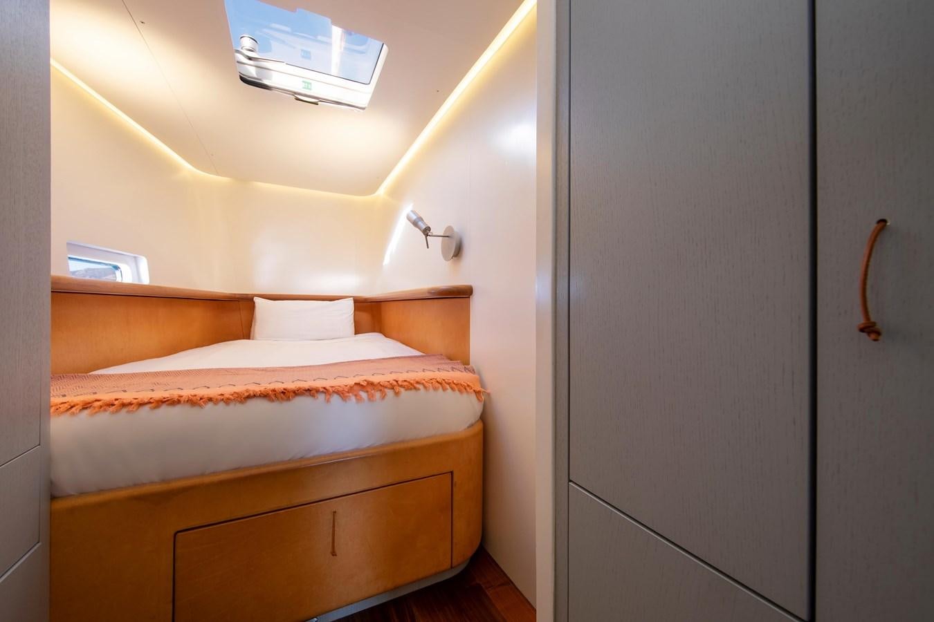 a room with a bed and a closet aboard PEREGRIN Yacht for Sale