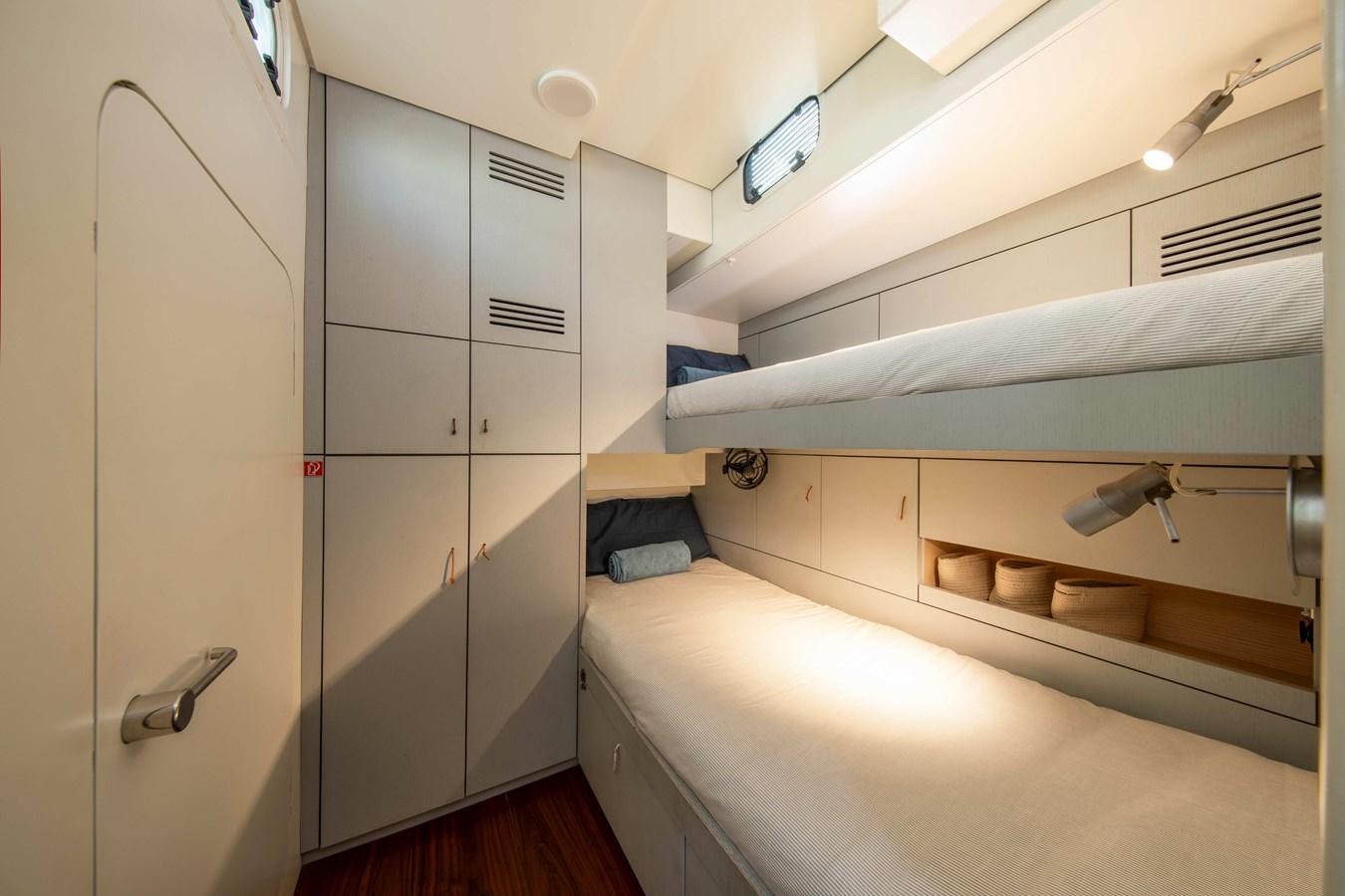 a room with a bed and cabinets aboard PEREGRIN Yacht for Sale