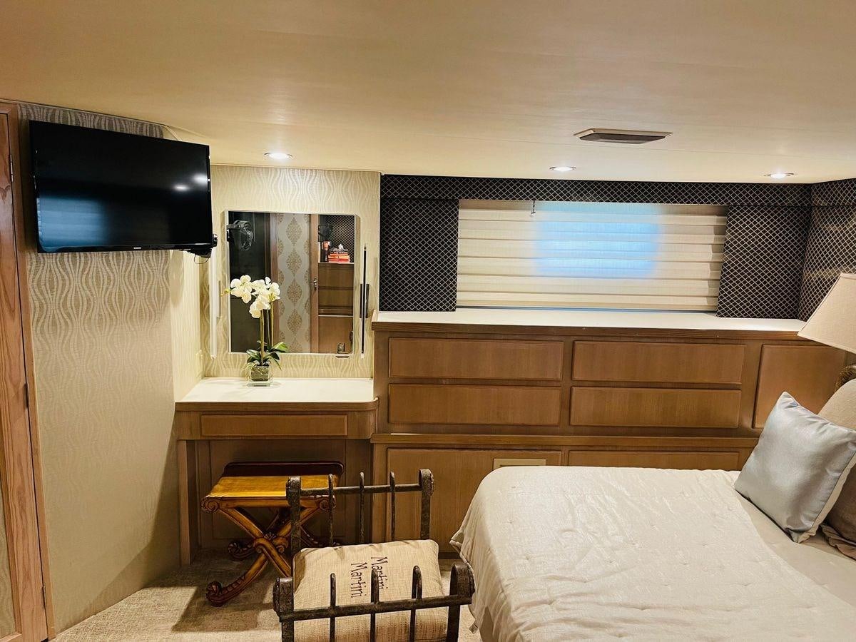 a bedroom with a tv and a bed aboard MARTINI MARTINI Yacht for Sale