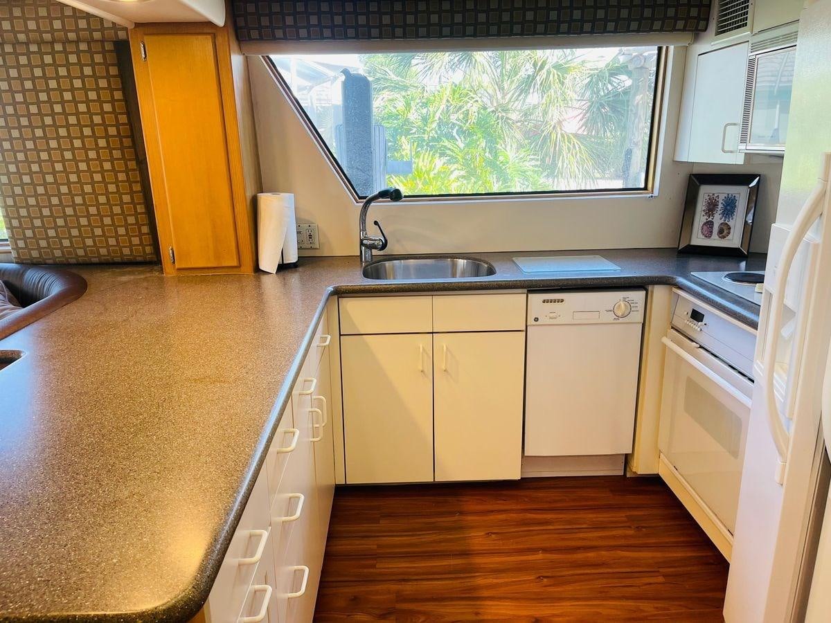 a kitchen with a sink and a window aboard MARTINI MARTINI Yacht for Sale