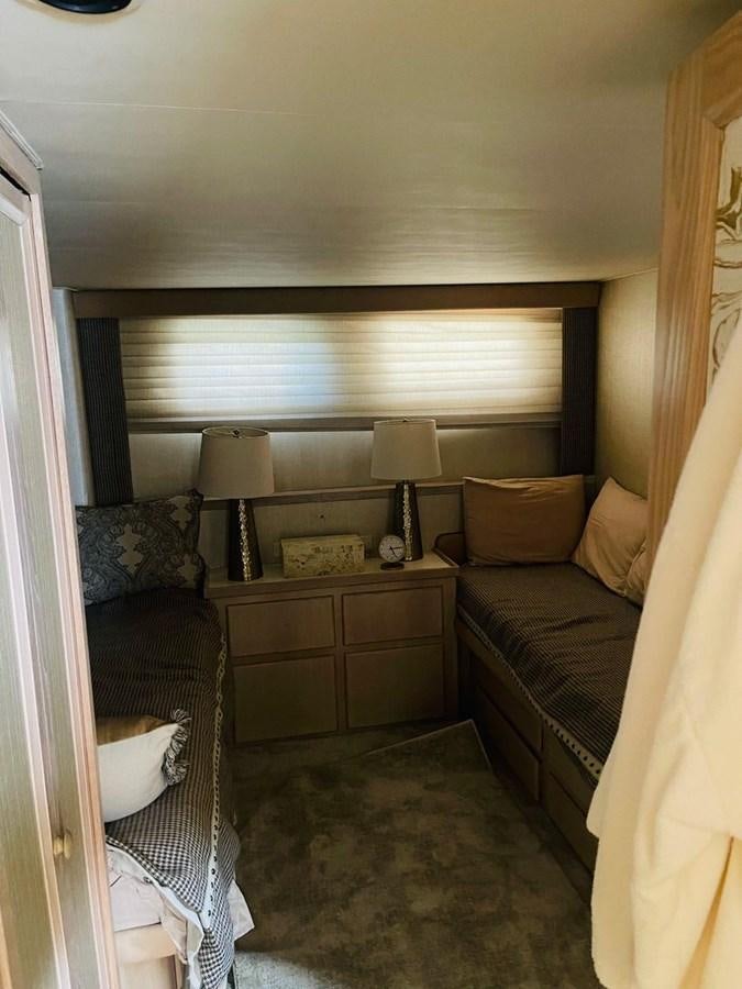 a bedroom with a bed and a dresser aboard MARTINI MARTINI Yacht for Sale