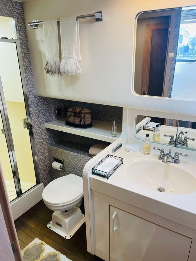 a bathroom with a toilet and sink aboard MARTINI MARTINI Yacht for Sale