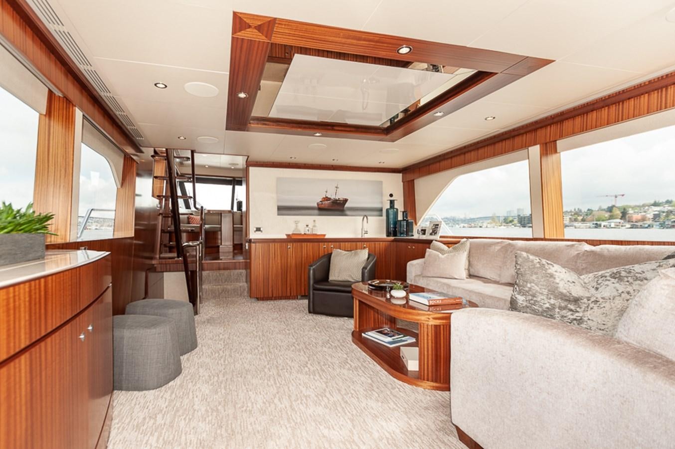 a living room with a large window aboard FOREVER INTREPID Yacht for Sale