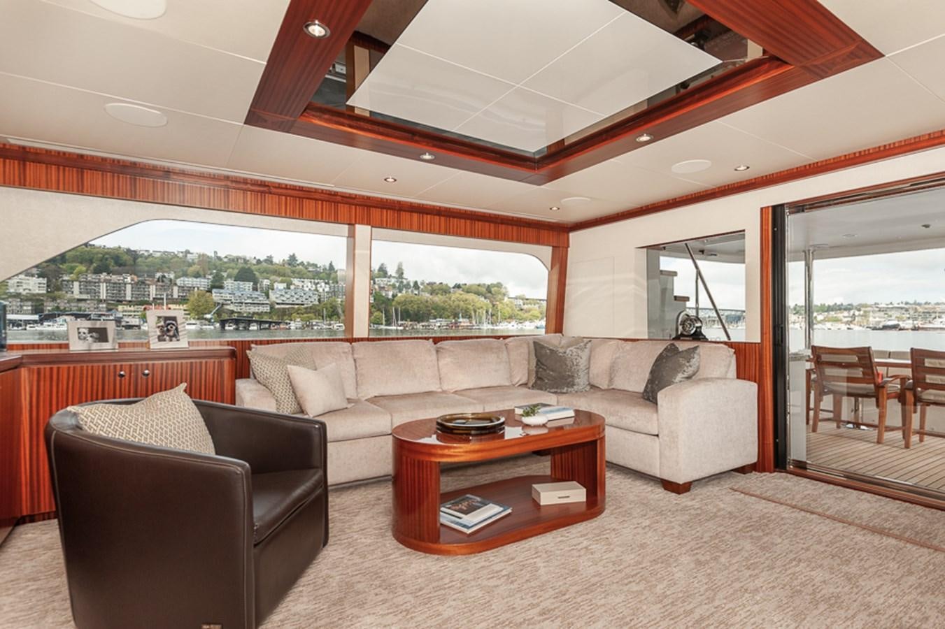 a living room with a couch and a table aboard FOREVER INTREPID Yacht for Sale