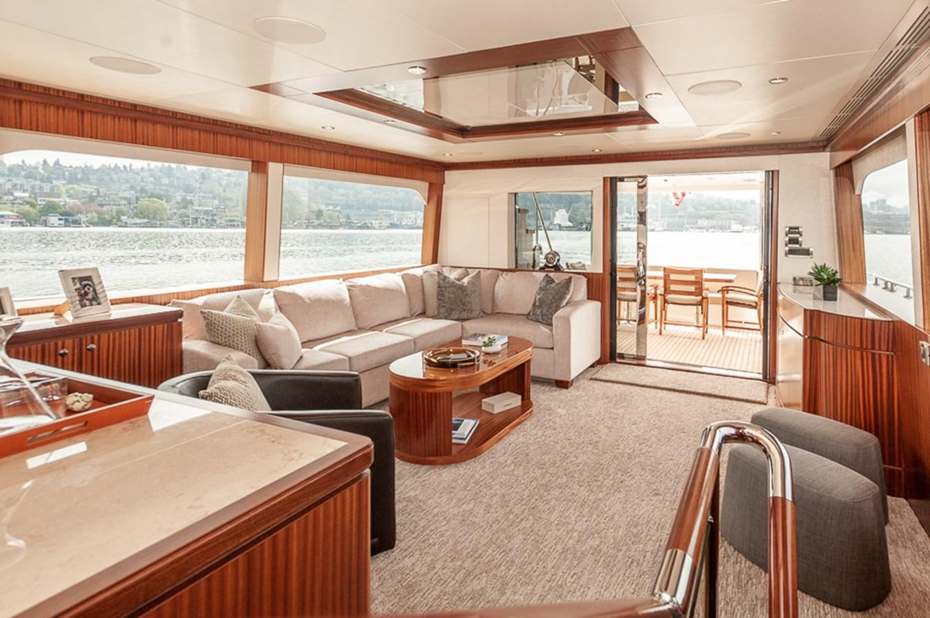 a living room with a large window aboard FOREVER INTREPID Yacht for Sale