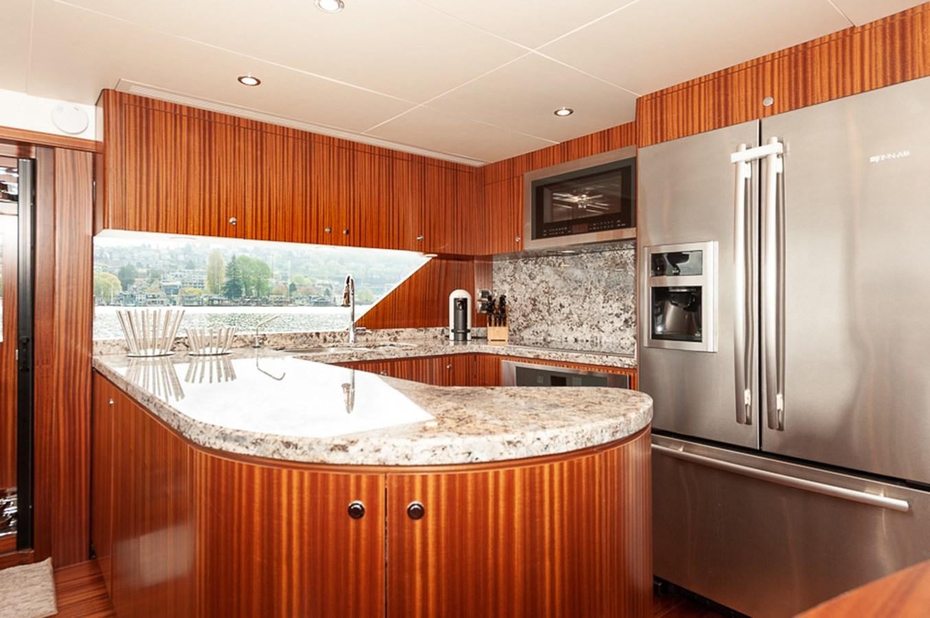 a kitchen with a large island aboard FOREVER INTREPID Yacht for Sale