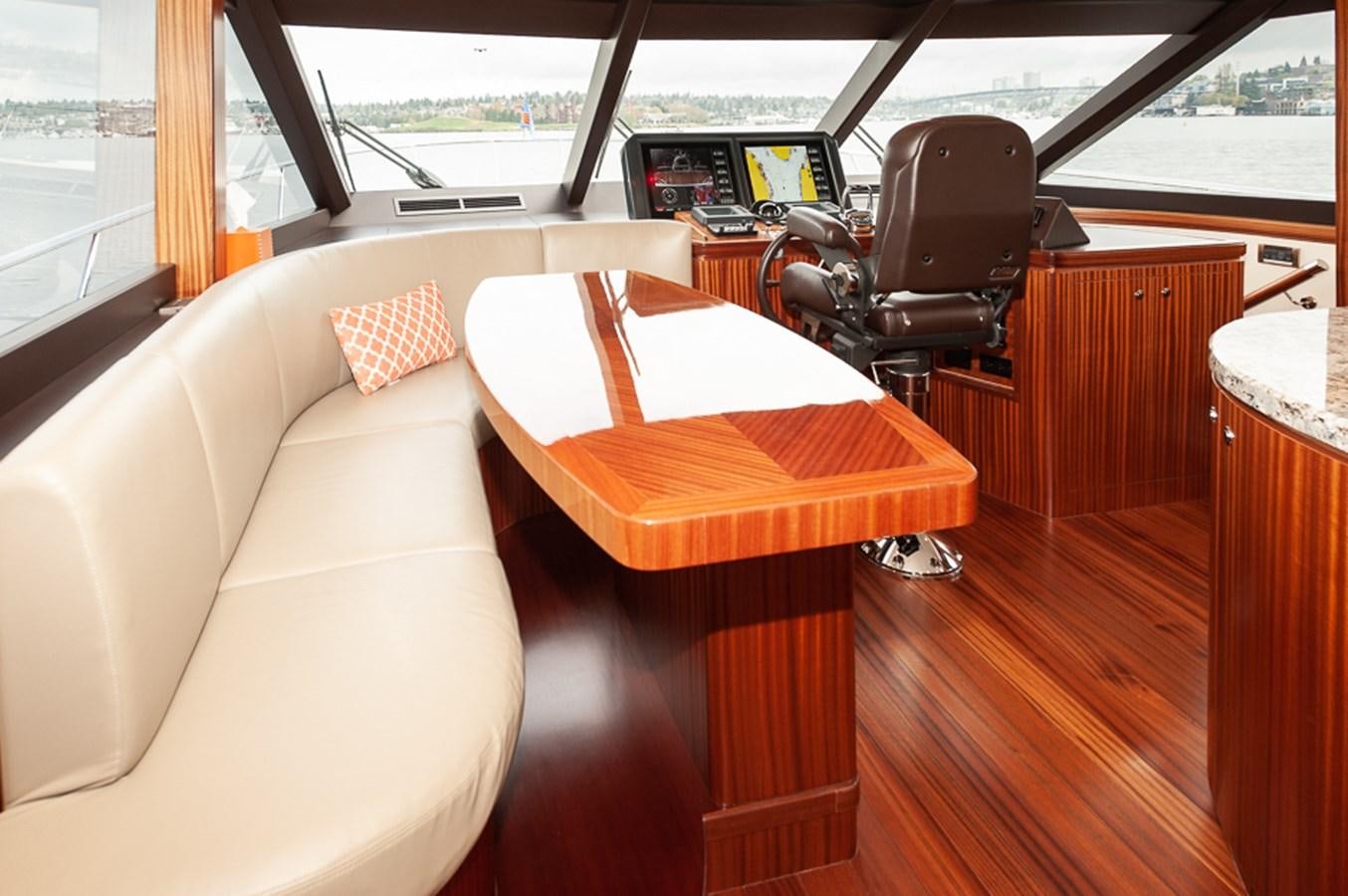 a table and chairs in a room aboard FOREVER INTREPID Yacht for Sale