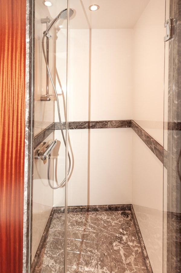 a shower with a tile floor aboard FOREVER INTREPID Yacht for Sale