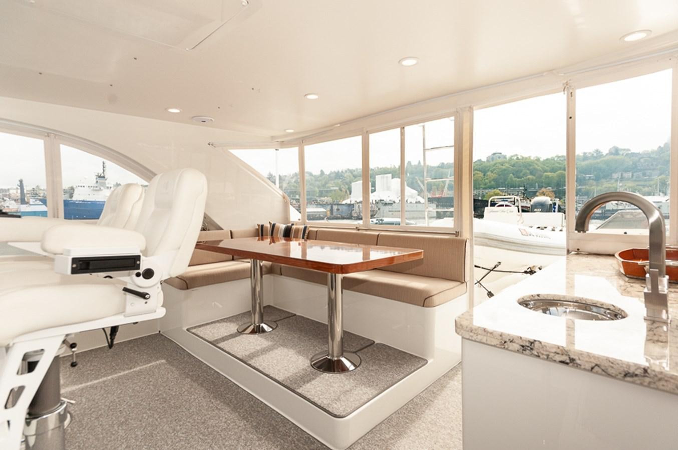 a room with a table and chairs aboard FOREVER INTREPID Yacht for Sale