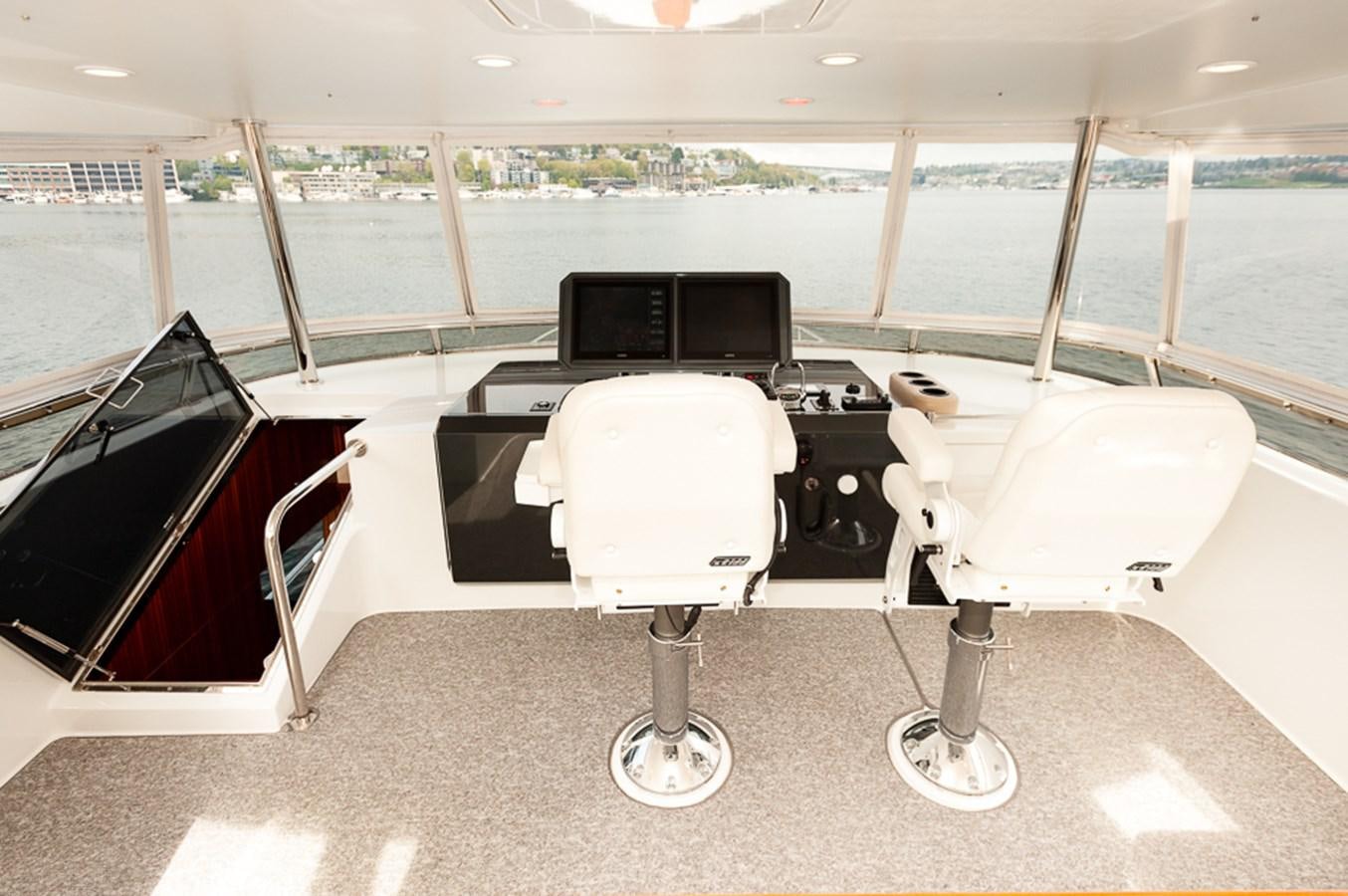 a couple of white desks with computers on them in a room with a large window with a aboard FOREVER INTREPID Yacht for Sale
