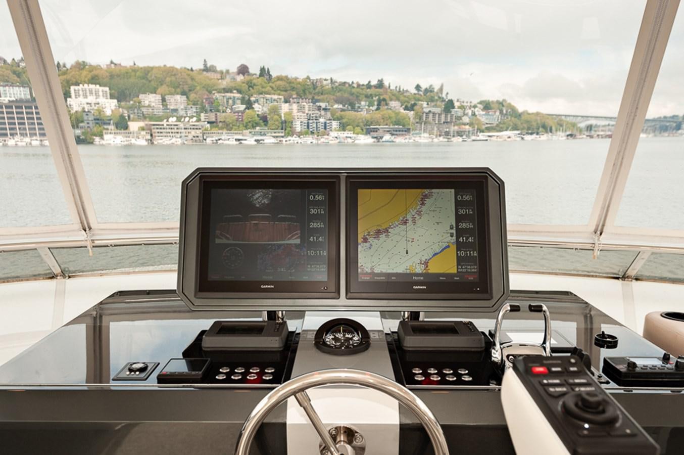 a desk with computers and a television aboard FOREVER INTREPID Yacht for Sale