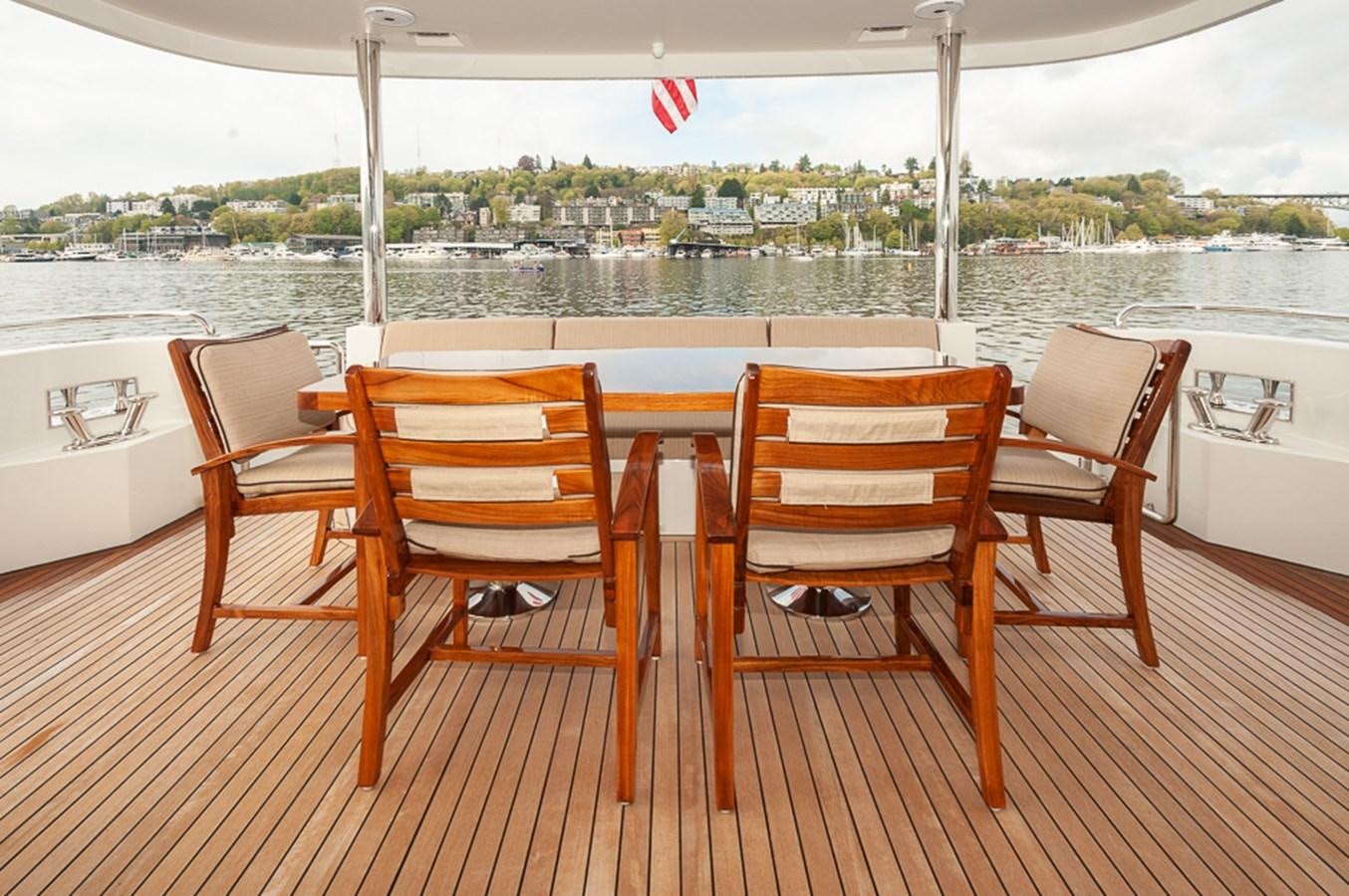 a table and chairs on a deck aboard FOREVER INTREPID Yacht for Sale