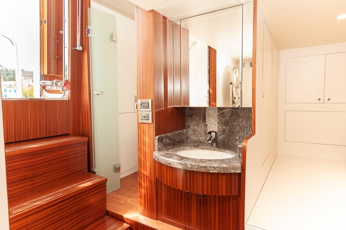 a bathroom with a sink and a mirror aboard FOREVER INTREPID Yacht for Sale