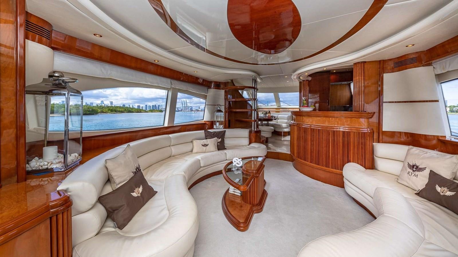a large room with a bed and a table aboard SALT SHAKER Yacht for Sale