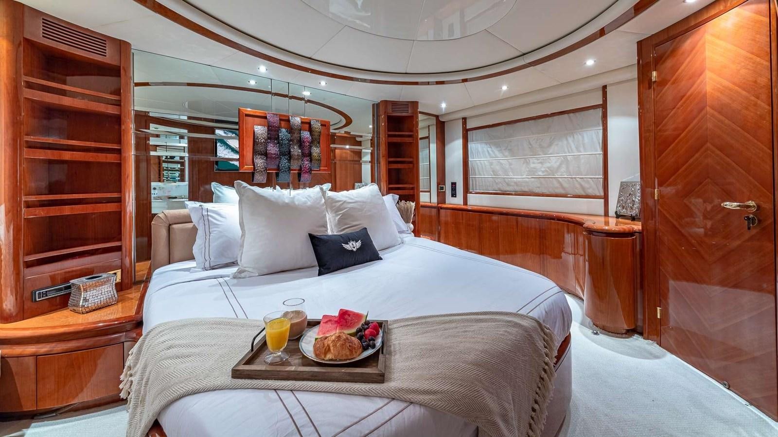 a bed with a tray of food and drinks on it aboard SALT SHAKER Yacht for Sale