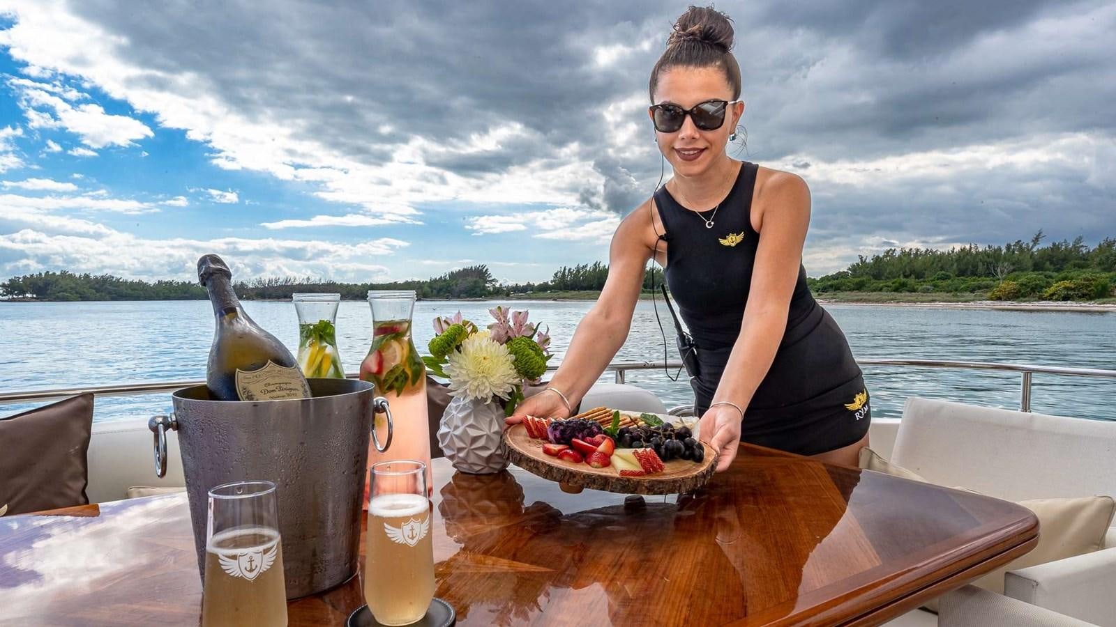 a person holding a plate of food aboard SALT SHAKER Yacht for Sale