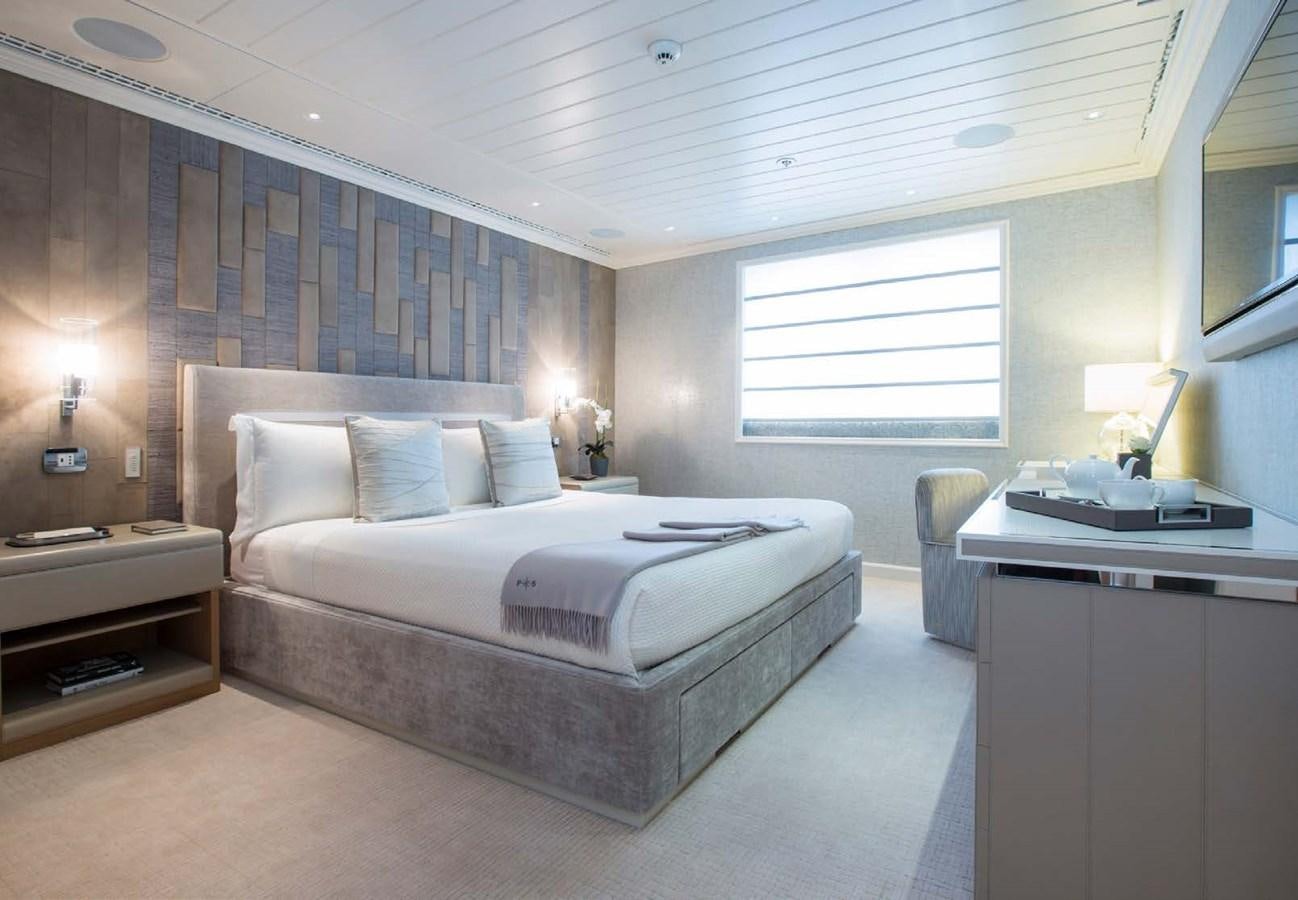 a bedroom with a bed and a desk aboard POLAR STAR Yacht for Sale