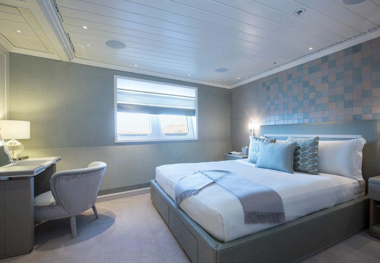 a bedroom with a bed and a desk aboard POLAR STAR Yacht for Sale