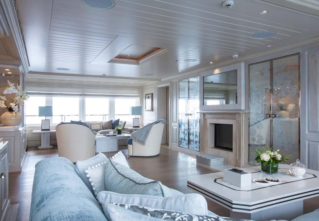 a living room with a fireplace aboard POLAR STAR Yacht for Sale