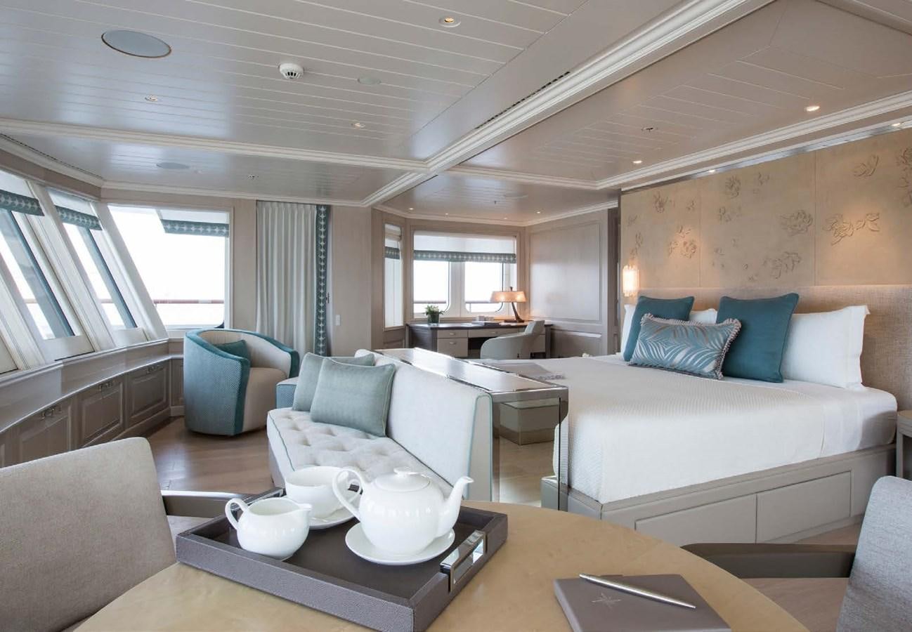 a living room with a couch and a table aboard POLAR STAR Yacht for Sale