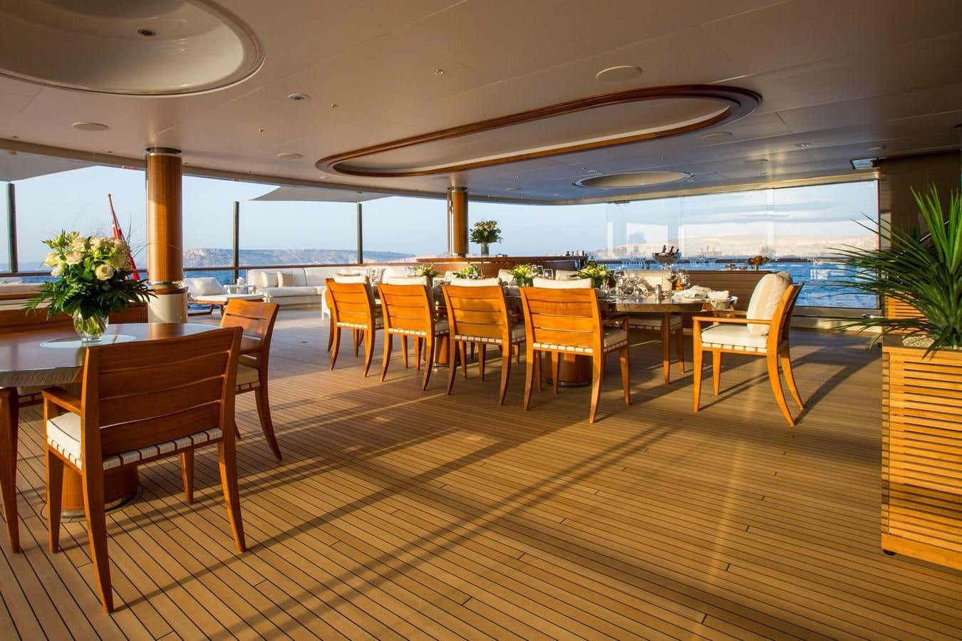 a room with tables and chairs aboard POLAR STAR Yacht for Sale