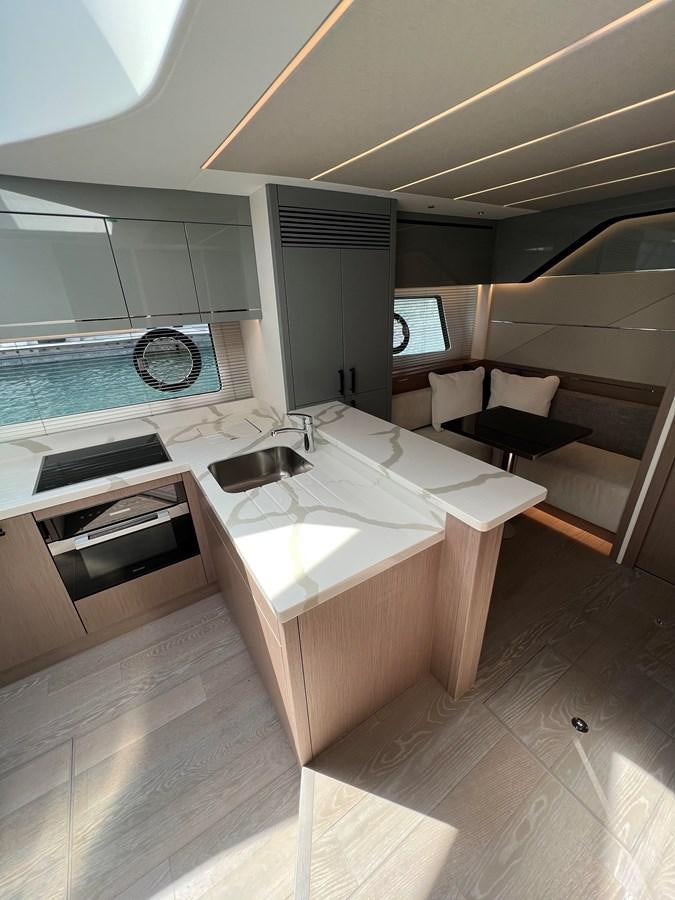 a modern bathroom with a large window aboard 2023 SUNSEEKER 65 SPORT Yacht for Sale