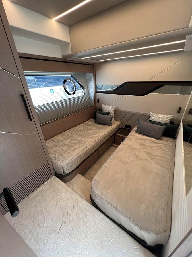 a room with a bed and a window aboard 2023 SUNSEEKER 65 SPORT Yacht for Sale