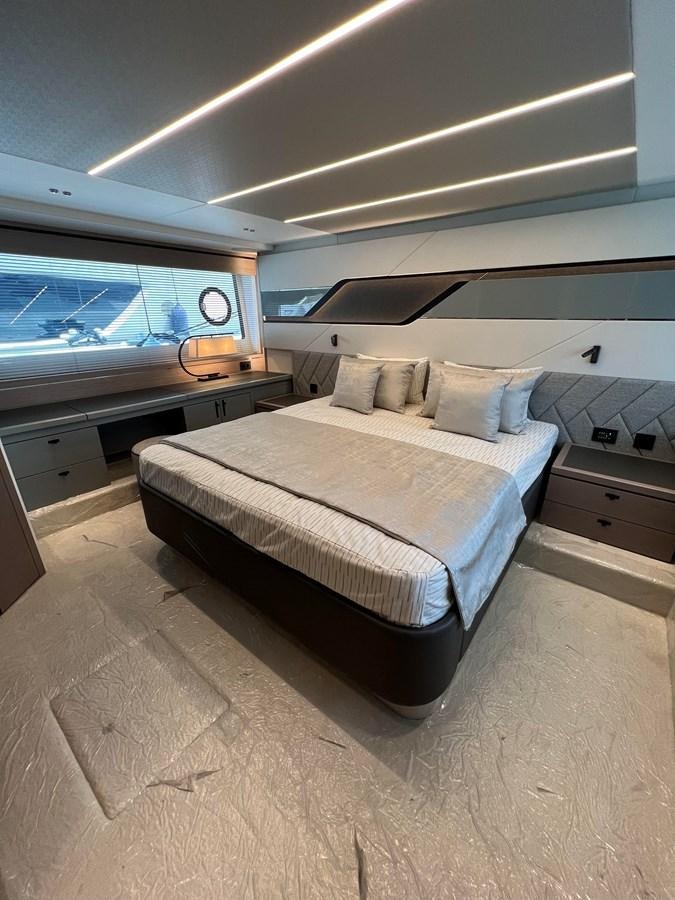a bed in a room aboard 2023 SUNSEEKER 65 SPORT Yacht for Sale