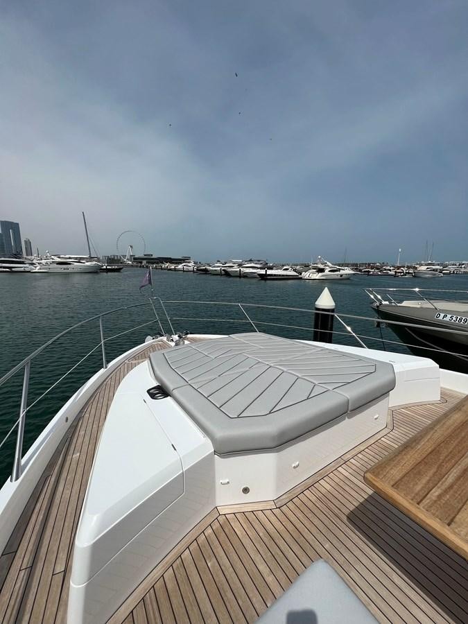 a deck of a boat with many boats in the water aboard 2023 SUNSEEKER 65 SPORT Yacht for Sale