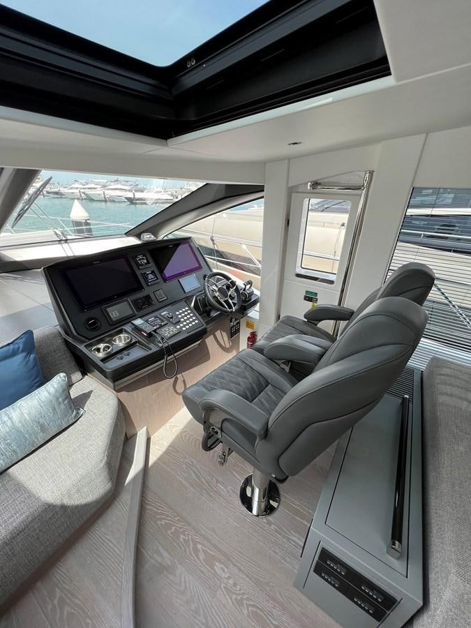 a living room with a couch and a tv aboard 2023 SUNSEEKER 65 SPORT Yacht for Sale