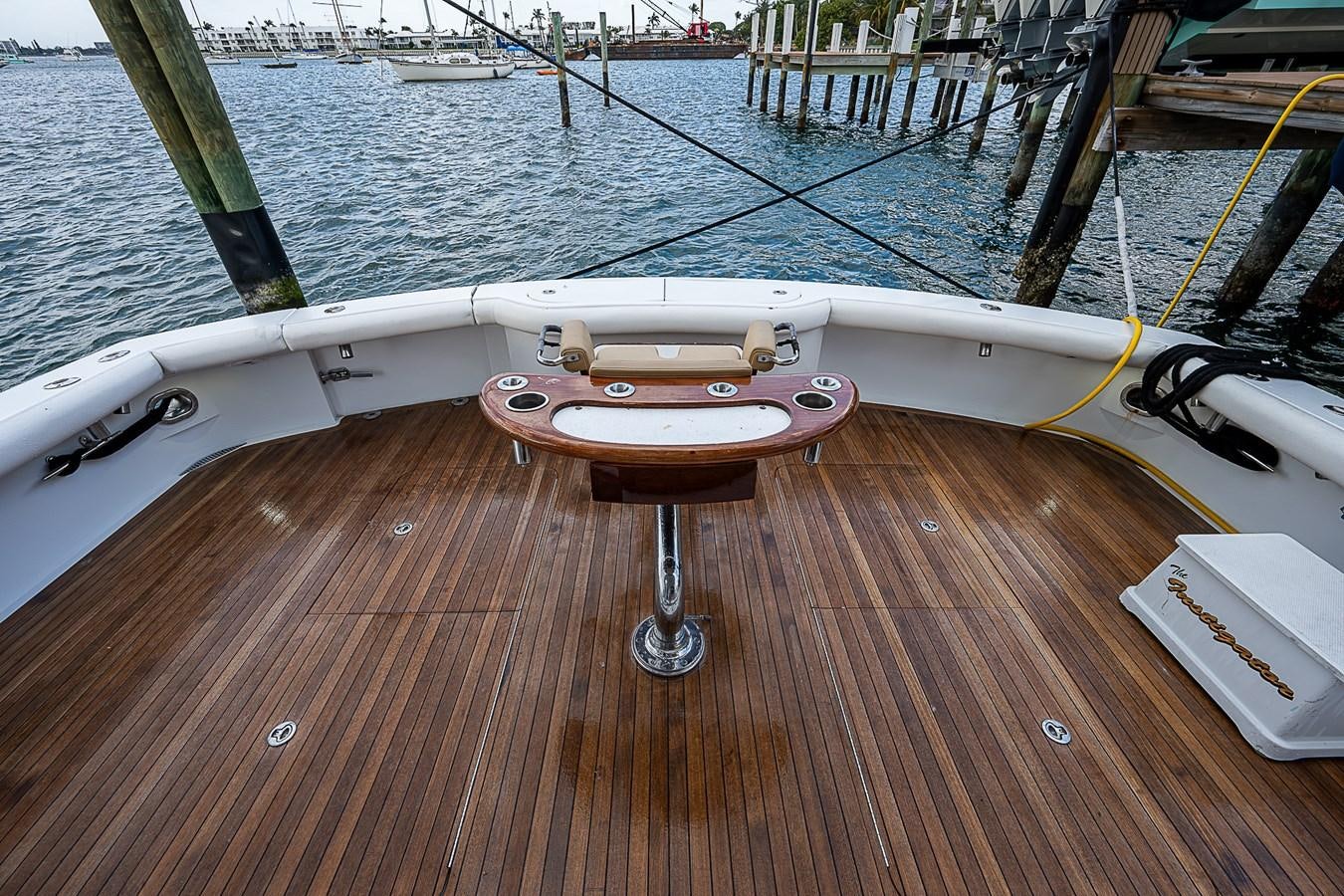 a wooden boat on a dock aboard INSTIGATOR Yacht for Sale