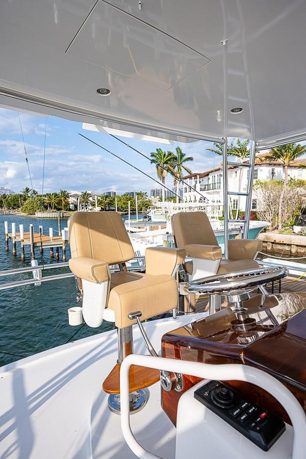 a boat with chairs and a table on it aboard INSTIGATOR Yacht for Sale