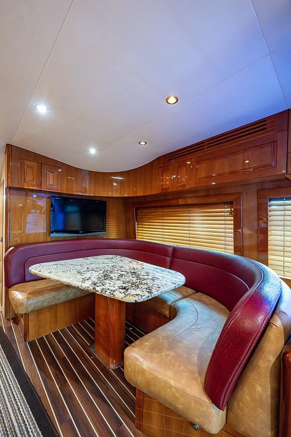 a living room with a table and couches aboard INSTIGATOR Yacht for Sale