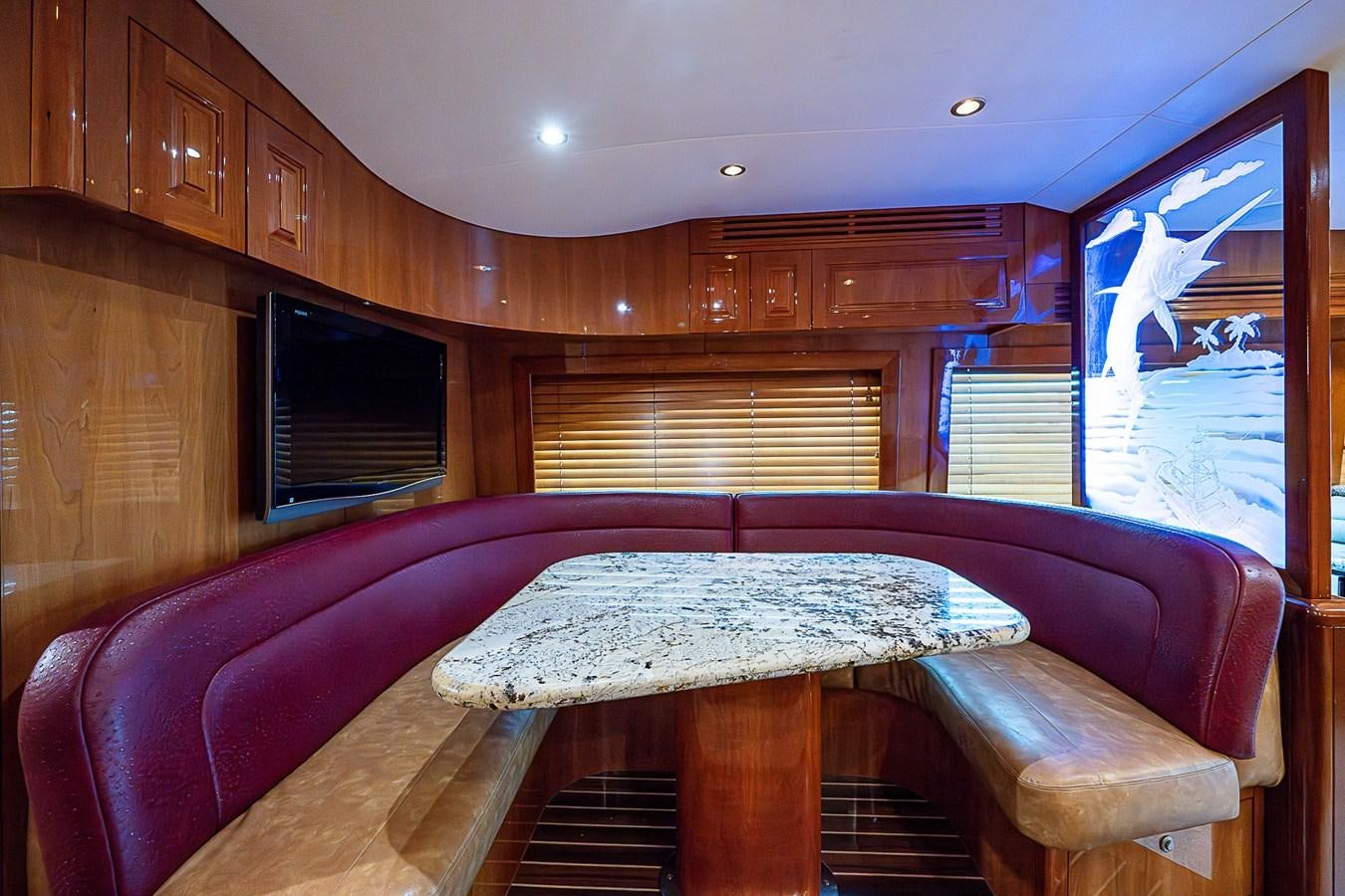a cabin with a bed and a table aboard INSTIGATOR Yacht for Sale