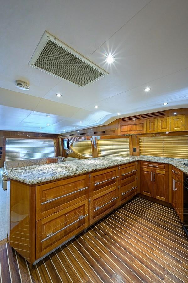 a large kitchen with wooden cabinets aboard INSTIGATOR Yacht for Sale