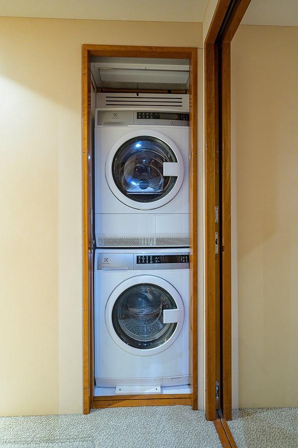 a closet with a washing machine aboard INSTIGATOR Yacht for Sale