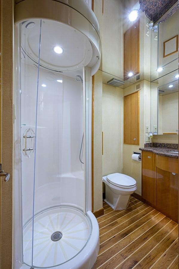 a bathroom with a shower and toilet aboard INSTIGATOR Yacht for Sale