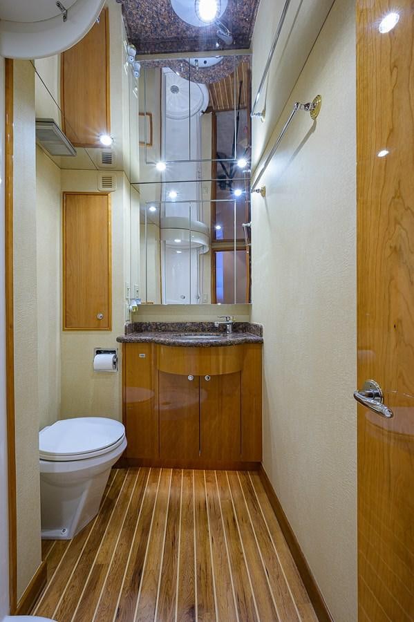 a bathroom with a sink toilet and a mirror aboard INSTIGATOR Yacht for Sale