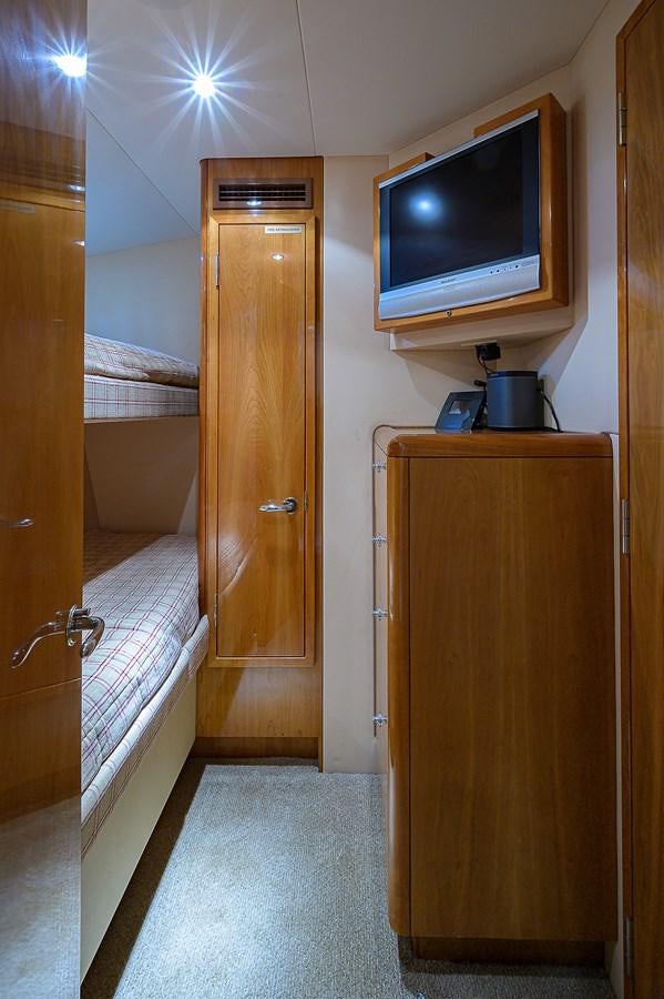 a bathroom with a television on the wall aboard INSTIGATOR Yacht for Sale