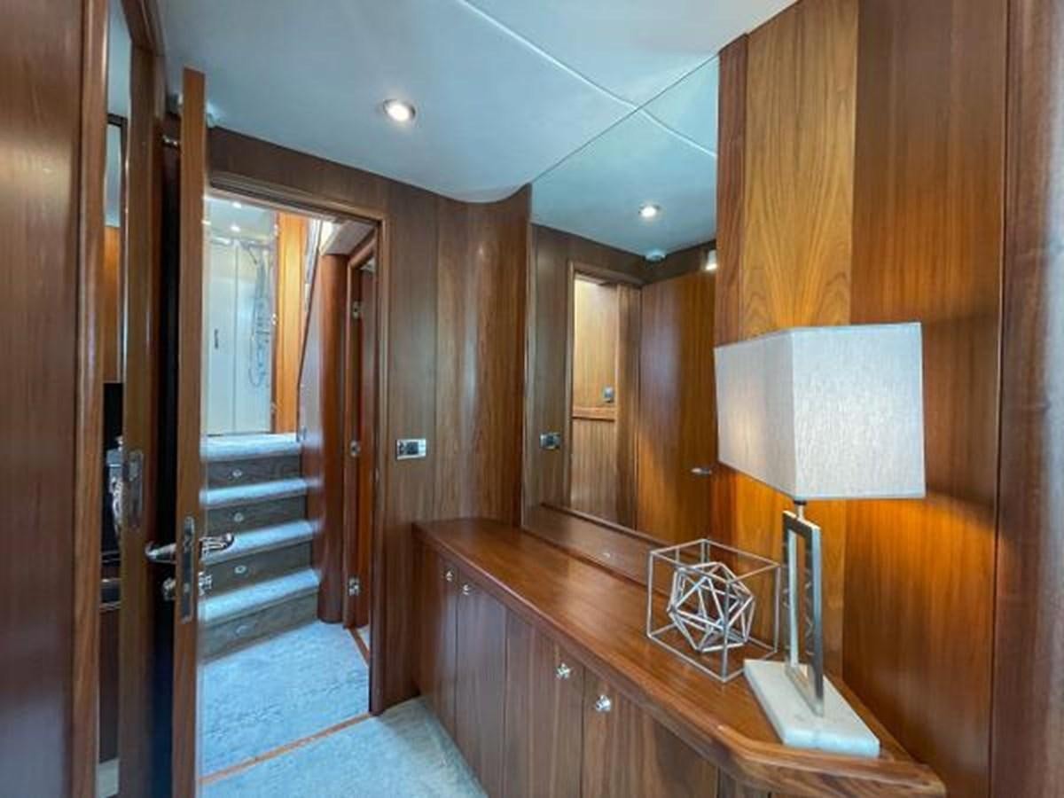 a wood paneled bathroom with a wood door and a wood cabinet aboard TWINS Yacht for Sale