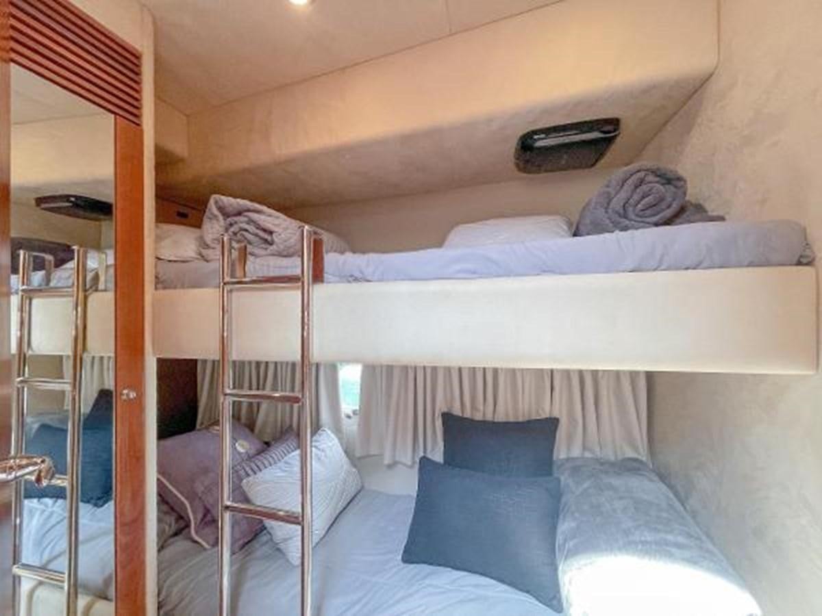 a bunk bed with a white bed aboard TWINS Yacht for Sale