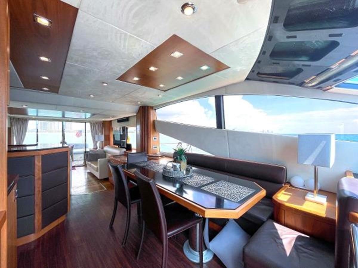 a large room with a table and chairs aboard TWINS Yacht for Sale